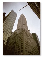 Sepia photograph of a skyscraper viewed from street level